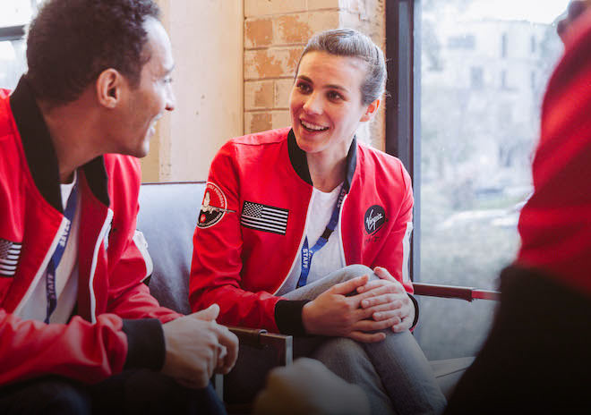 Company employees wearing custom bomber jackets