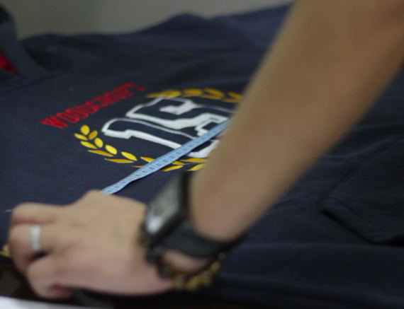 A person inspecting the fabric for shrinkage