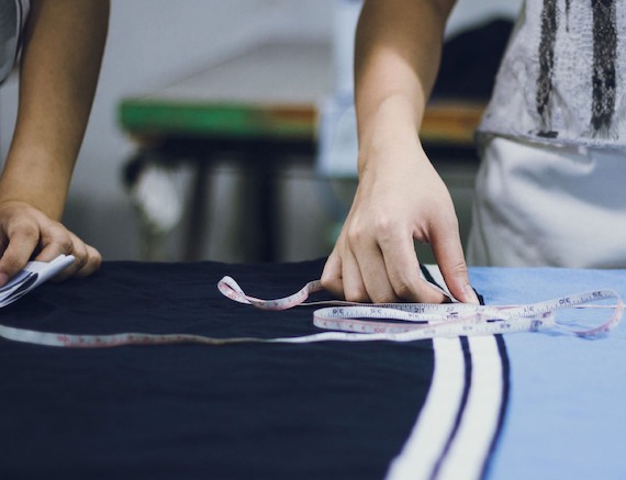 A person measuring fabric